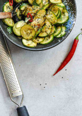 A courgette dish served and the Westmark Gallant Pro Fine Grater resting on the table beside it