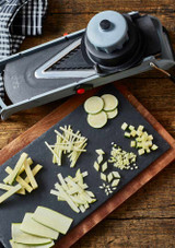 a wooden board with perfectly sliced and diced ingredients beside the De Buyer Viper Mandoline