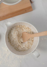top view of flour and wooden spoon in the Costa Nova Casafina Fattoria Batter Bowl - White - 2.05 L