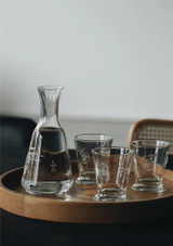 La Rochere Fleur de Lys Tumbler 250ml Set of 6 on a tray with other tumblers and a jug of water