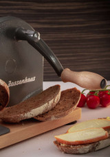 Zassenhaus Bread slicer in grey on a table with bread ready to serve