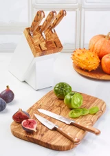Lion Sabatier Ideal 5 Piece Knife Set with Arles White & Olive Wood Block on a counter with fruits