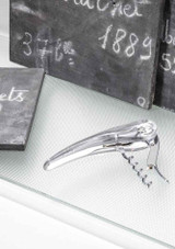 L’Atelier du Vin Soft Machine Crystal – transparent sommelier corkscrew with visible gear mechanism, built-in foil cutter, shown on a table.