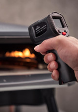 Man holding Pizza Oven infrared temperature gun at a fired pizza oven Man holding Pizza Oven infrared temperature gun at a fired pizza oven