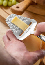 Boska Cheese Slicer Monaco+ – stainless steel handheld slicer with quilted blade pattern and ergonomic handle, shown slicing cheese. Boska Cheese Slicer Monaco+ – stainless steel handheld slicer with quilted blade pattern and ergonomic handle, shown slicing cheese.