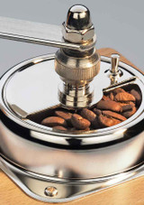 Zassenhaus Brasilia Manual Coffee Grinder – beechwood body, hand-crank burr mill, shown close up of grinder with coffee beans.
