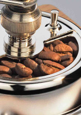 Zassenhaus Coffee Mill Montevideo – manual coffee grinder with walnut and pearwood body, shown close up of grinder with coffee beans. Zassenhaus Coffee Mill Montevideo – manual coffee grinder with walnut and pearwood body, shown close up of grinder with coffee beans.