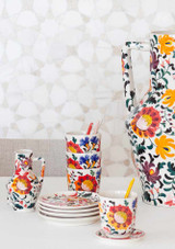 A display of Return to Sender vases and cups on a table with hand painted floral prints A display of Return to Sender vases and cups on a table with hand painted floral prints