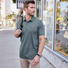 Model wearing a Travismathew Sunnyvale polo with embroidered Watkins Wellness logo.