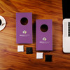 Burgundy Cornholio Desktop Cornhole set with Watkins Wellness logo on a desk with computer and coffee cup.