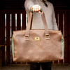 Danville Duffel with Watkins Wellness logo being held by a hand.