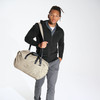 Model carrying Mercer+Mettle® Claremont Duffel bag on shoulder.