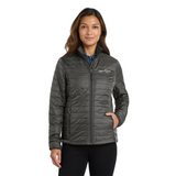 Freeflow Ladies Packable Puffy Jacket in Grey with white logo on model. 
