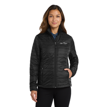 Freeflow Ladies Packable Puffy Jacket in black with white logo on model. 