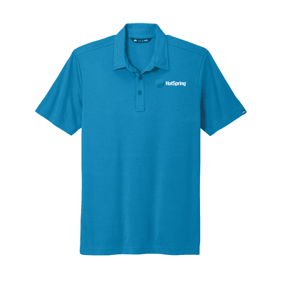 Model is wearing TravisMathew Oceanside Solid Polo in Blue color