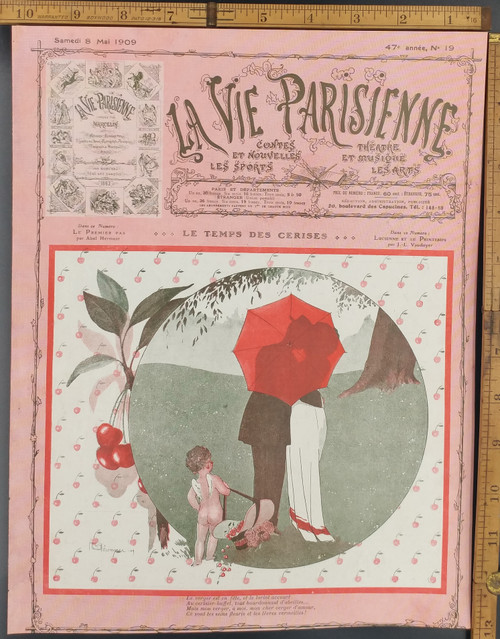 Le temps des cerises. The cherry season. Cupid and a couple kissing behind an umbrella. Original Antique French color print from 1909.