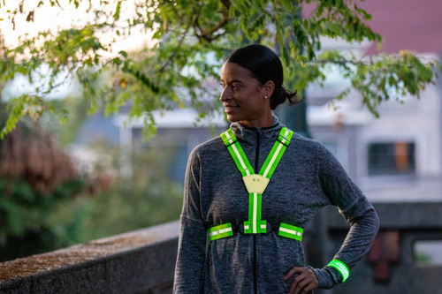 Woman wearing Xinglet™ adjustable reflective vest hi-viz yellow