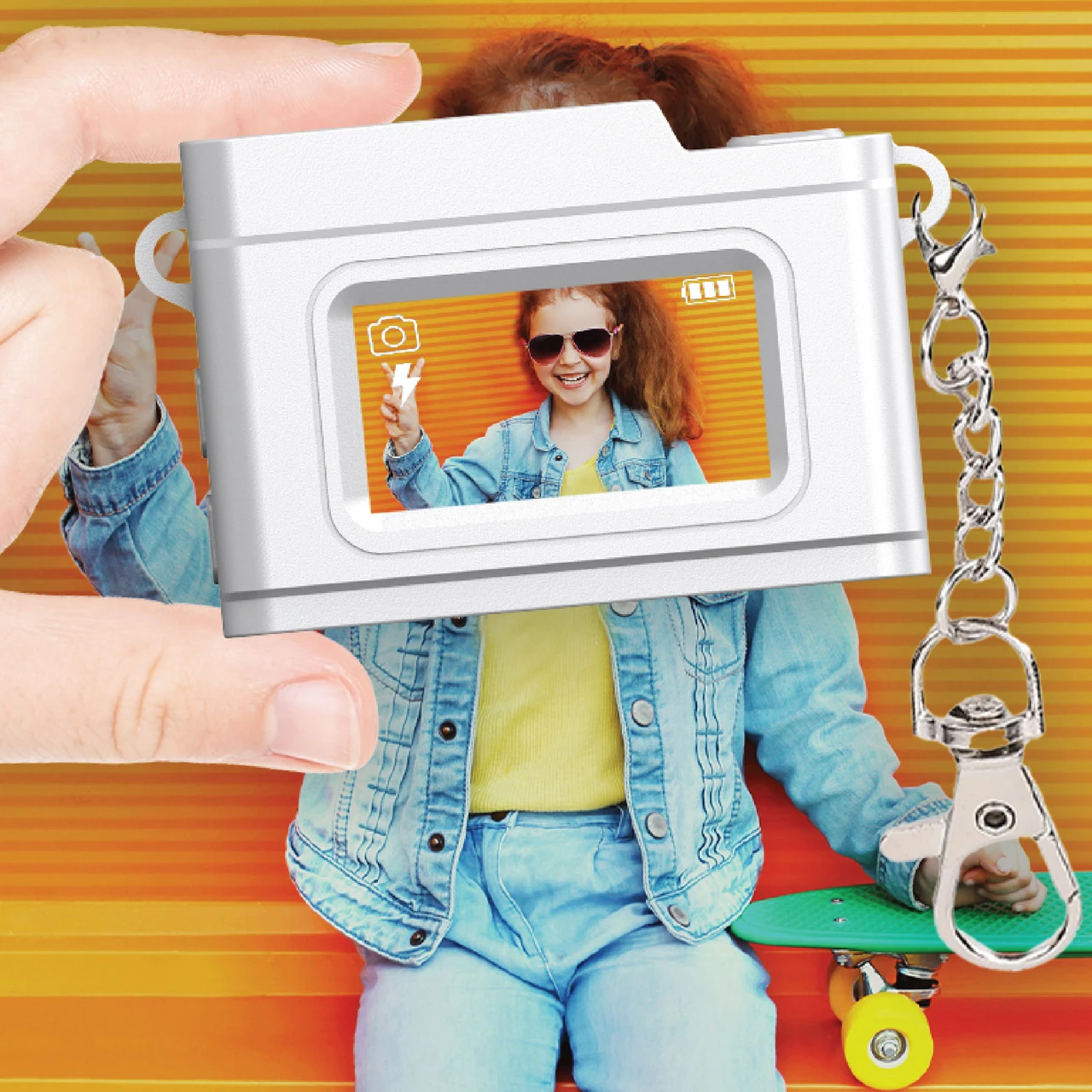 child holding Laser pink kids mini digital camera with photo preview