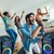 Group of friends singing karaoke with Laser Party Speaker