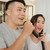 Couple singing with wireless microphones and Laser Party Speaker