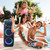 Family by the pool with Laser Party Speaker in the background