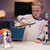 Boy playing with a space shuttle next to astronaut Bluetooth speaker
