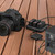 portable power station charging camera batteries outdoors on wooden deck for photography use
