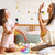 girl and woman singing indoors with blue wireless microphones and karaoke speaker