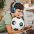Laser kids wired headphones blue worn by child using laptop at home while holding soccer ball