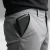 Compact black 5000mAh power bank with LED battery indicator carried in a trouser pocket