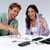 Baseus EnerFill FC41 charging phones on a table while two people play cards