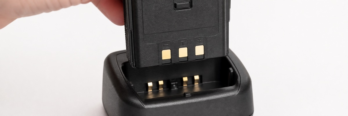 Baofeng walkie talkie battery seated in charging dock showing contact points for troubleshooting