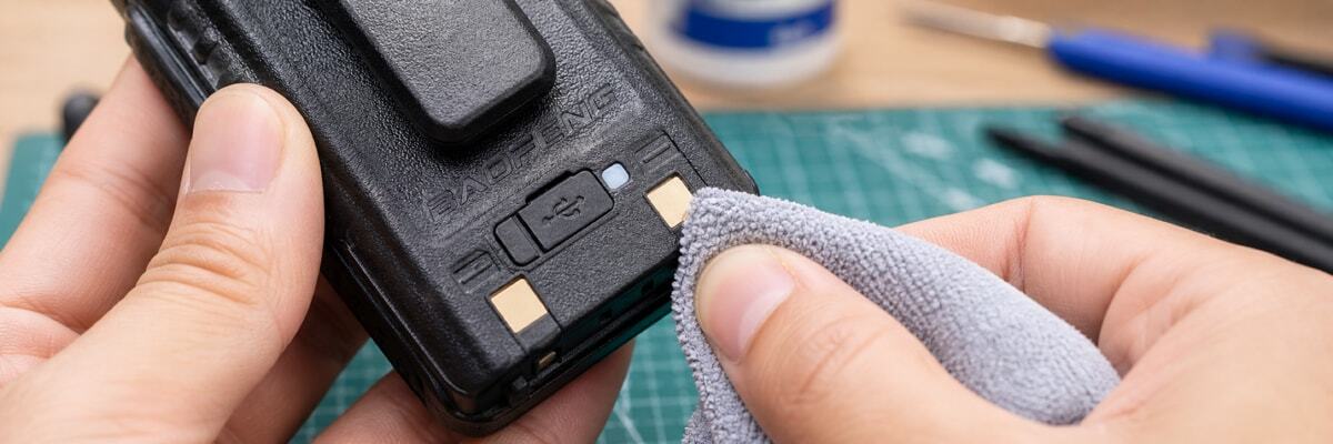 Cleaning radio battery contacts