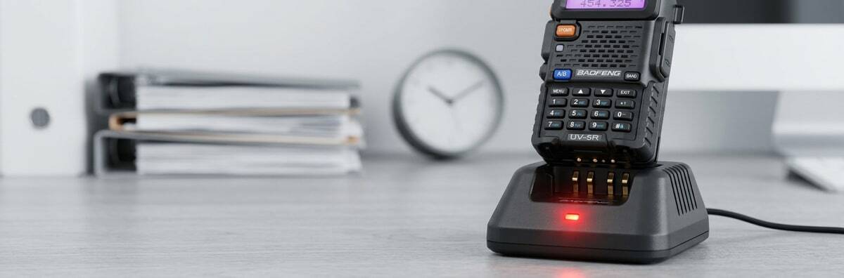 Baofeng radio low battery warning light on a charging base