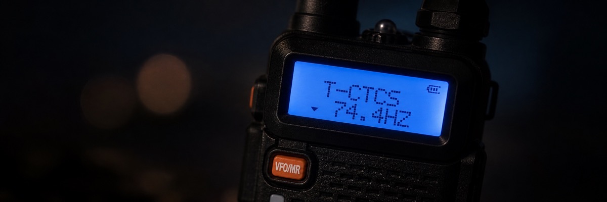 Wide macro shot of a walkie-talkie display screen showing active CTCSS privacy codes used to filter out unwanted chatter.