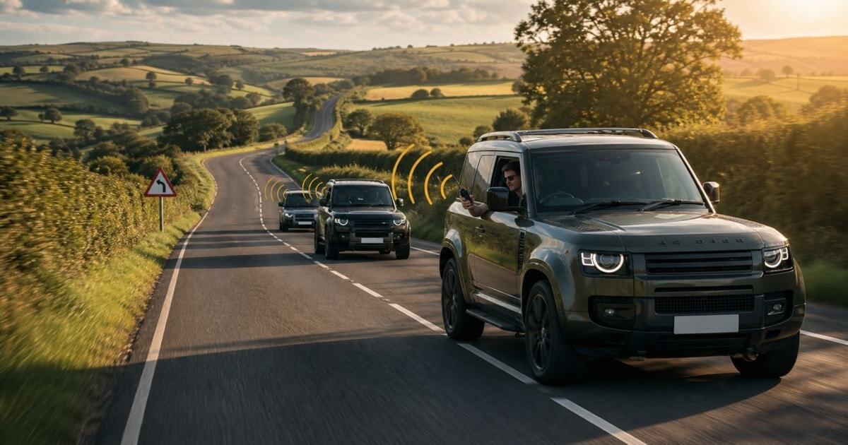 A three-car convoy driving along a scenic British road with a passenger in the lead car holding a walkie-talkie, illustrating how two-way radios keep road trip and car convoy groups connected