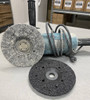 Black grinding wheel mounted on a 7 inch hand grinder