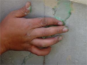 Vertical crack on a foundation wall repaired with 116 Caulk and tooled with soap on finger