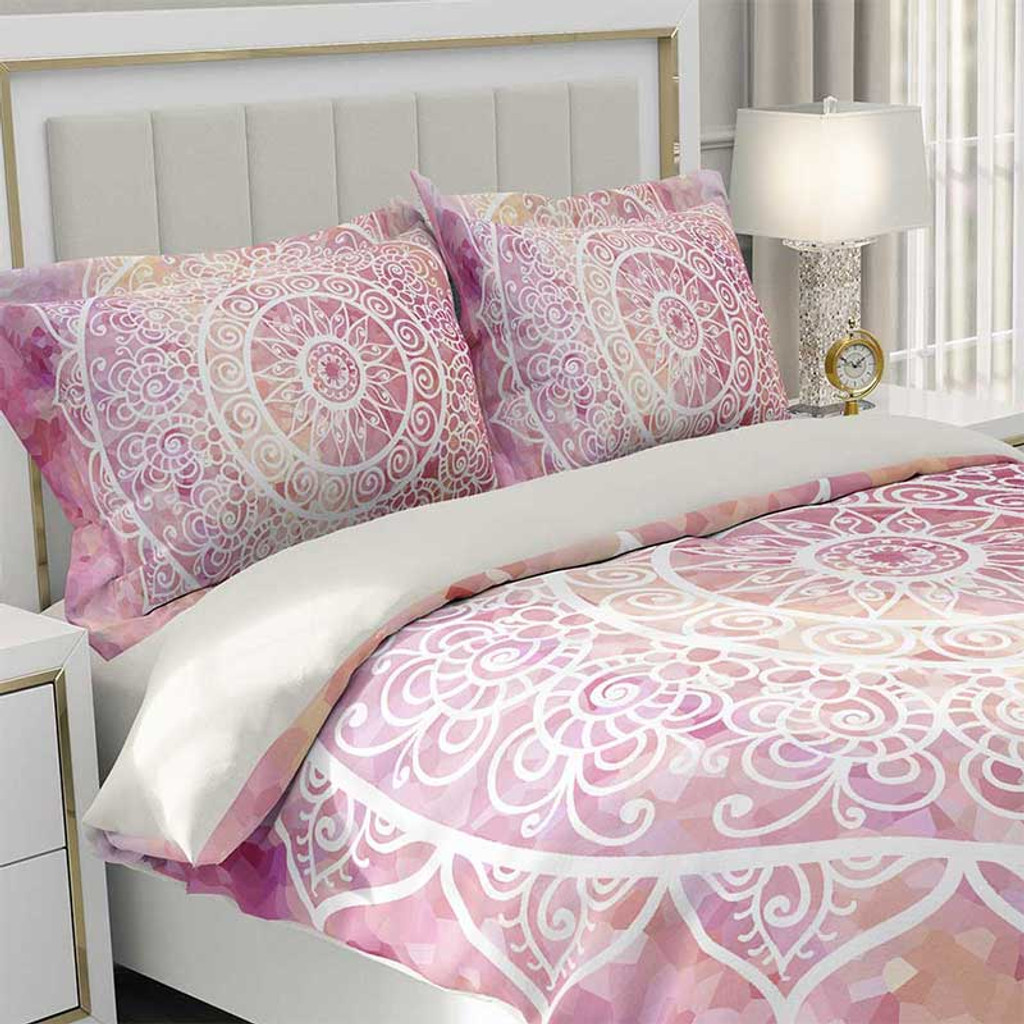 pink and white bedding with mandala design
