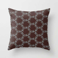 brown throw pillow with blue trellis pattern