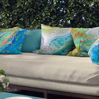 bright abstract outdoor pillows on the couch