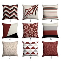 red, black and beige cushion covers with striped and floral patterns