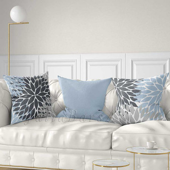 gray and light blue decorative pillows with floral patterns