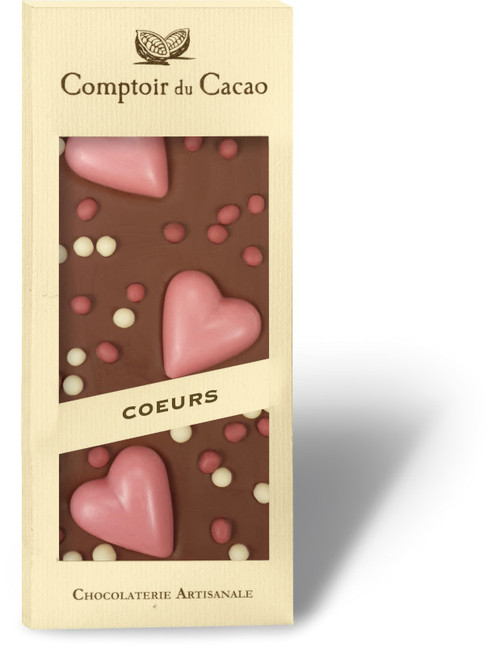 A 90 gram bar of milk chocolate covered with large pink hearts, from Comptoir du Cacao.