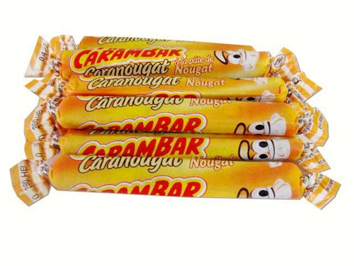 A 128 gram pile of 16 Carambar Caranougat candy sticks, individually wrapped with wax paper. Made by La Pie Qui Chante.