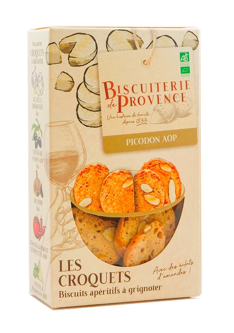 A 90 gram box of organic croquets with picodon, or goat cheese, from Biscuiterie de Provence. The crisp, thin crackers with almond pieces are visible through the box's window.