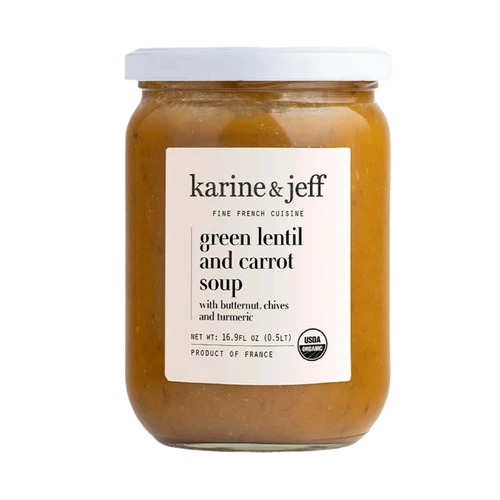 A 50 centiliter glass jar of organic green lentil and carrot soup from Karine & Jeff. The orange soup appears completely smooth.