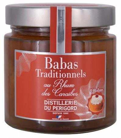 A 380 gram jar of babas with Caribbean rum from Distillerie du Périgord. The babas are suspended in a rich liquid in the jar.
