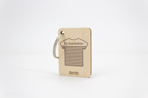 A key ring with a square wooden charm. The charm has an illustration of a striped t-shirt that is labeled "La marinière" in French.