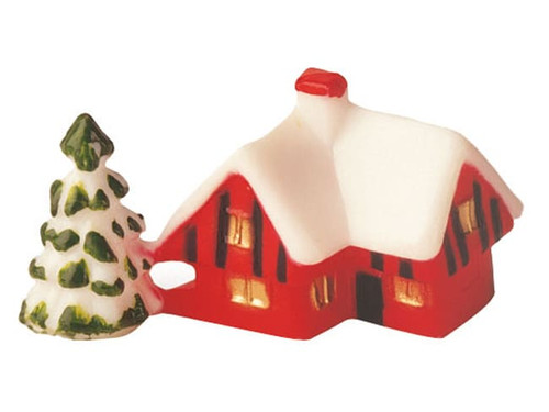 A tiny red cabin figurine, intended to be used as decor for a Bûche de Noël.